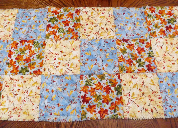 Back of autumn blue rag quilt table runner on dining room table 